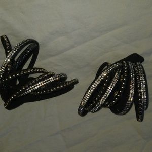 Pair of black, gold and silver wrap bracelets.